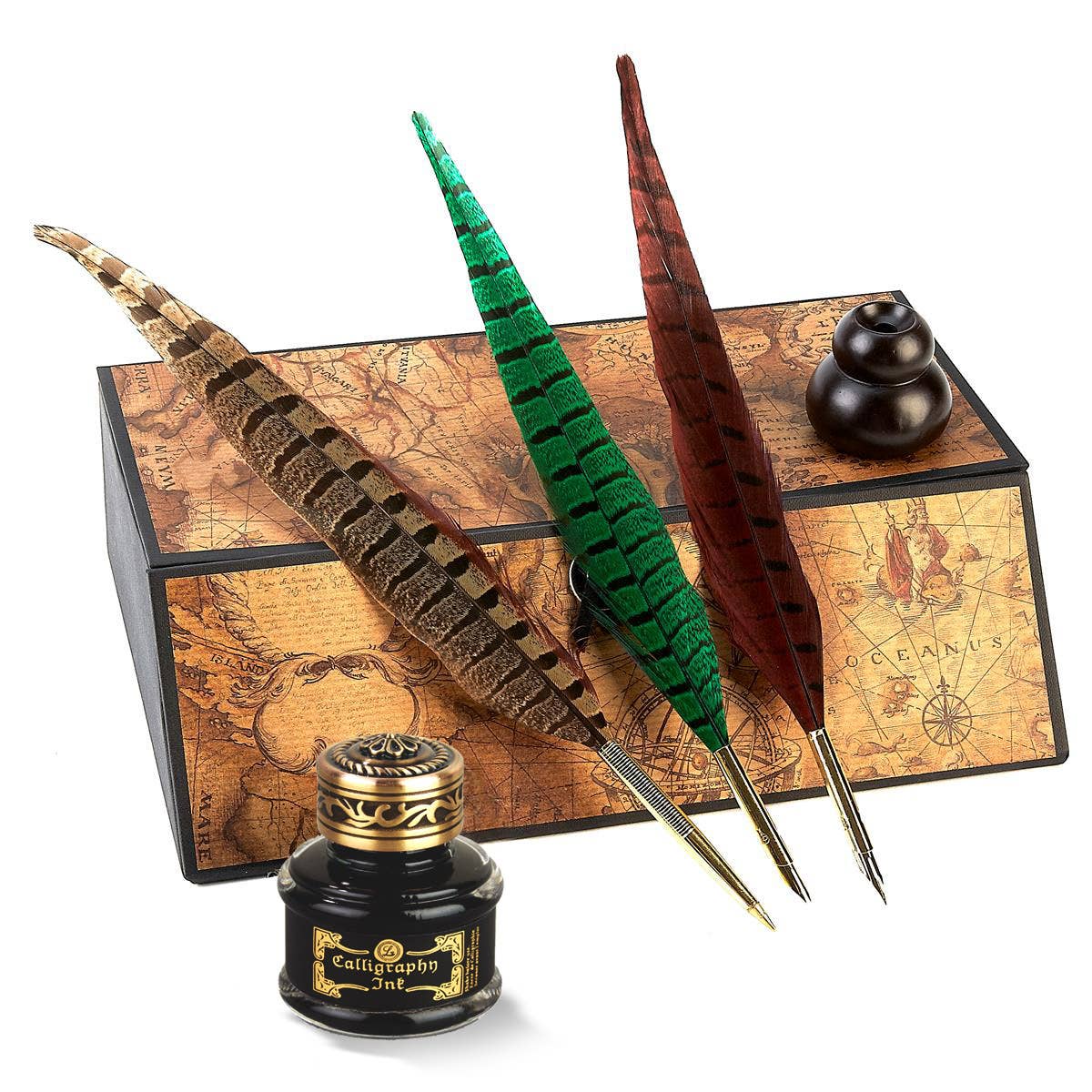 Feather quill pens and ink bottle with a decorative box on a white background