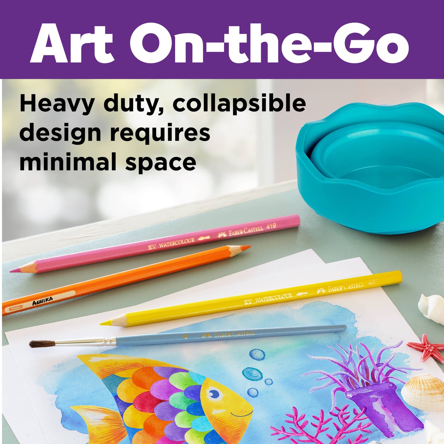 Art supplies including colored pencils and a painting of a fish on a table with a blue container.