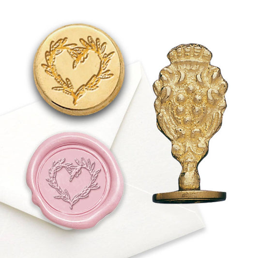 Decorative wax seal stamp set with gold and pink designs on a white background