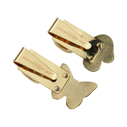 Gold butterfly clips with 'Designworks Ink' branding on a white background