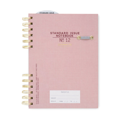 Pink notebook with gold spiral binding on a white background