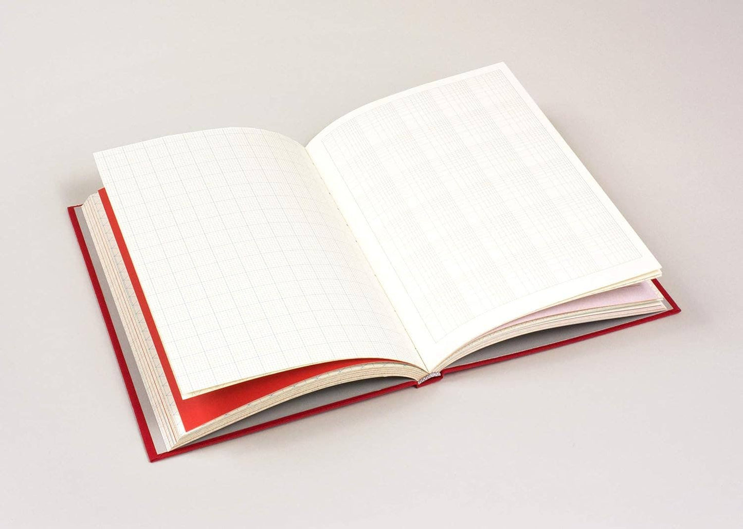 Open book with red binding on a white background