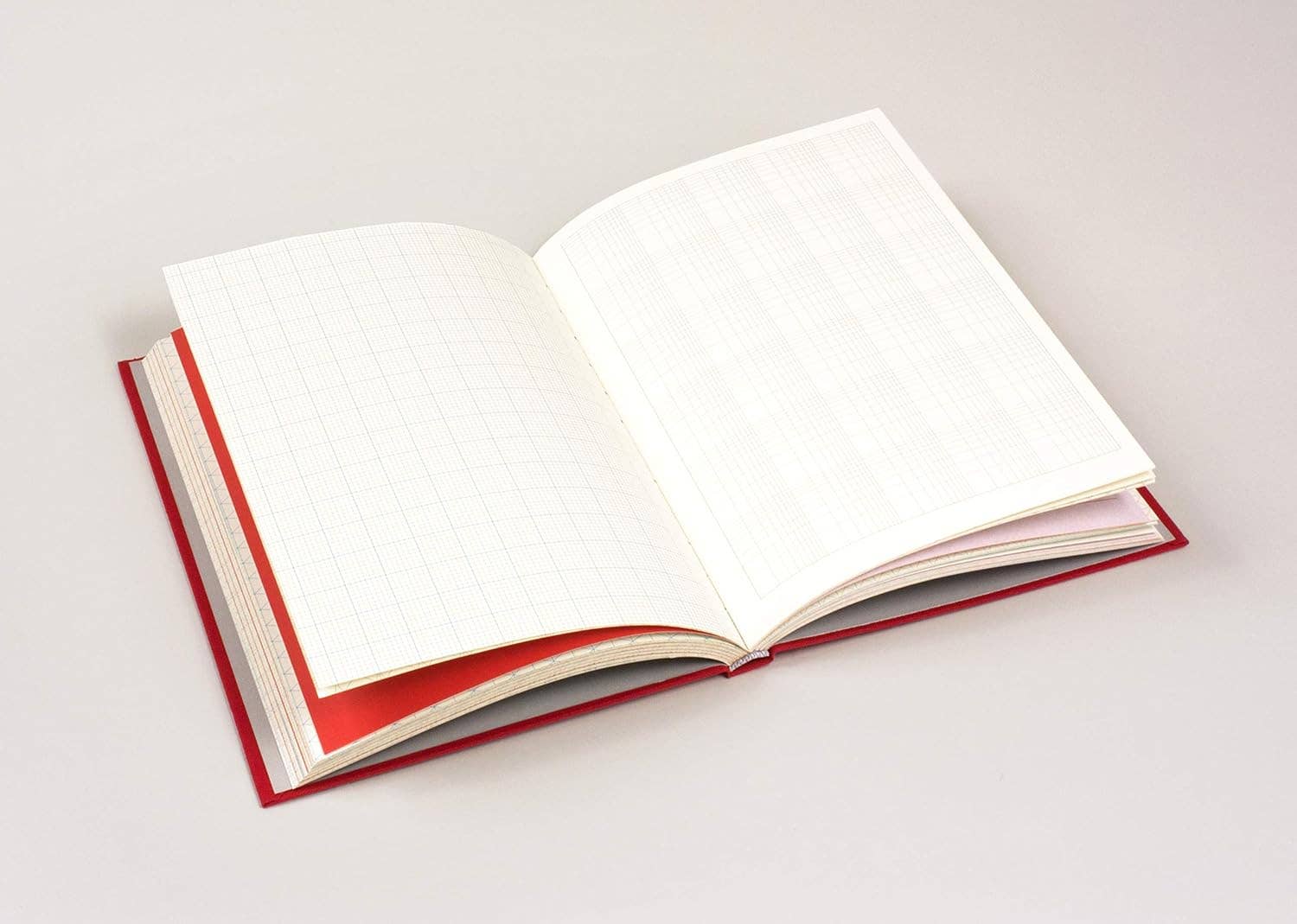 Open book with red binding on a white background