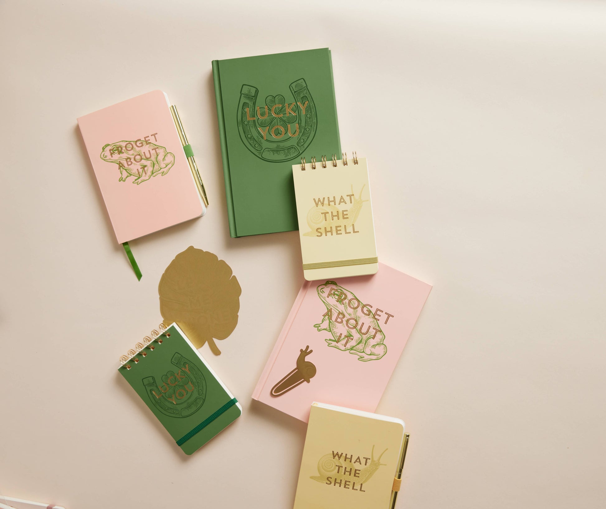Set of small notebooks with various designs and text on a light background