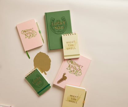Set of small notebooks with various designs and text on a light background
