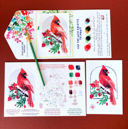Educational art kit with cardinal illustrations and color mixing guide on a red background