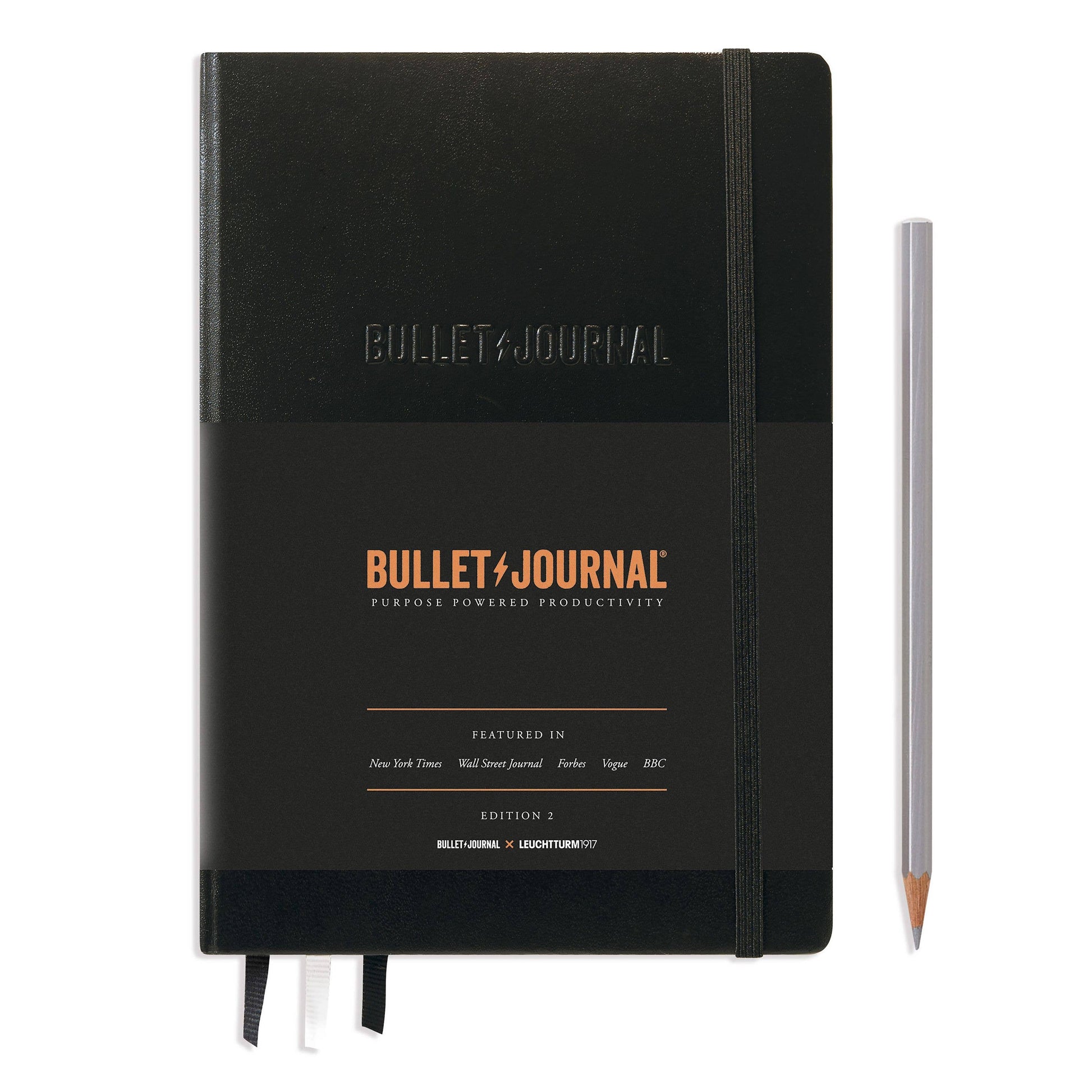 Black Bullet Journal notebook with a pencil on a white background