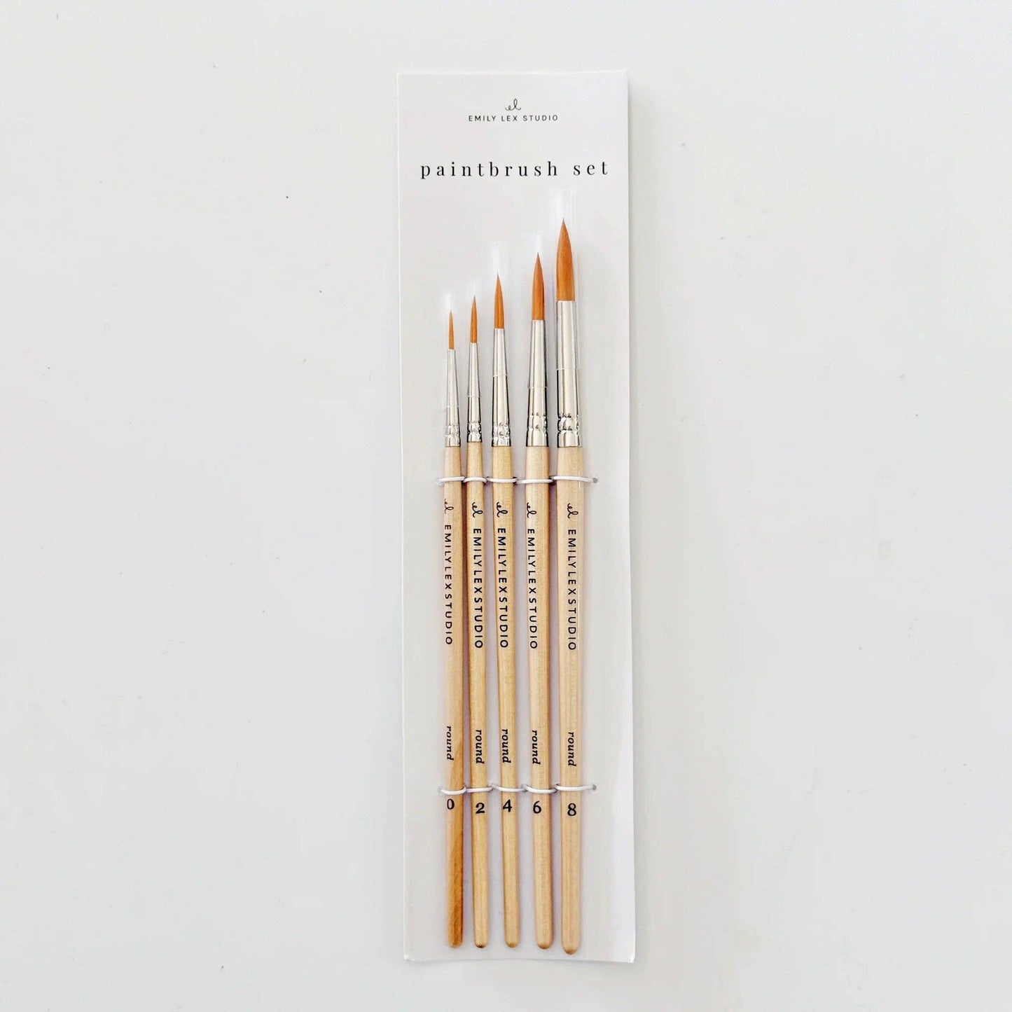 Set of paintbrushes in packaging on a white background