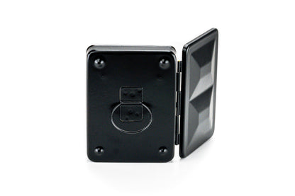 Black metal hinged box with a circular component on a white background