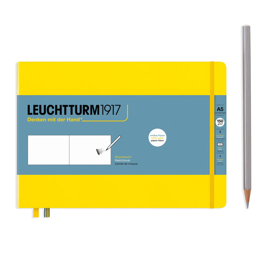 Yellow notebook with blue cover and a pencil on a white background