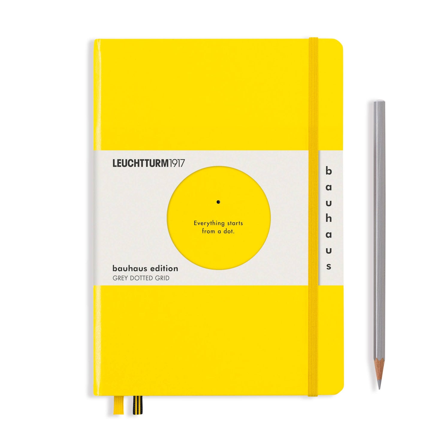 Yellow notebook with Bauhaus edition label and a pencil on a white background