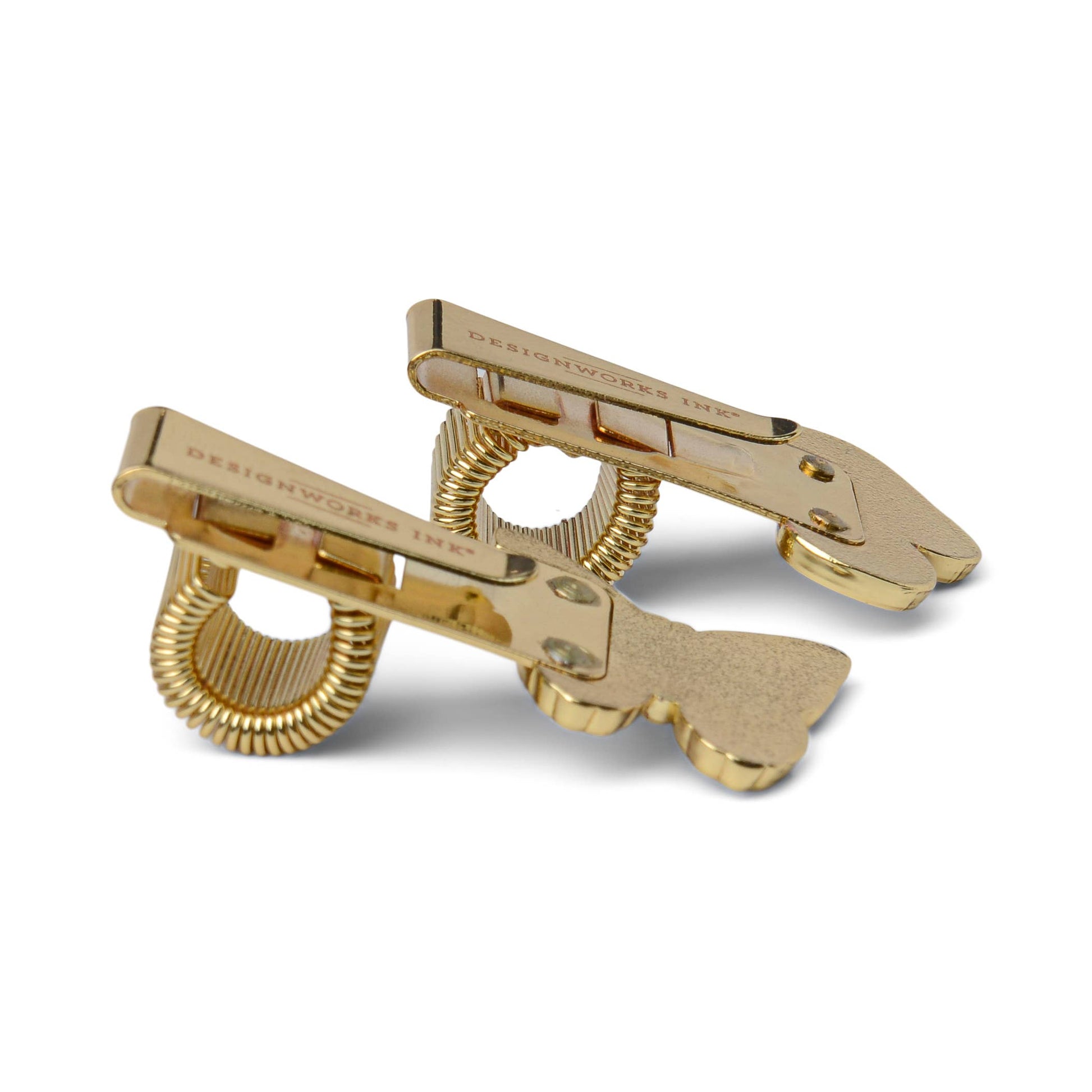 Gold-colored hair clips on a white background