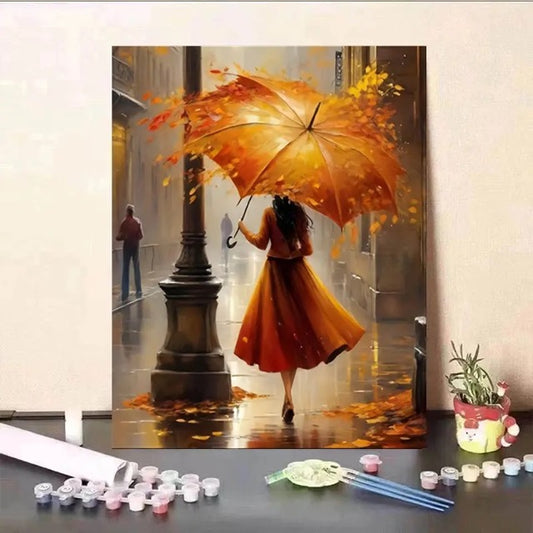Painting of a person with an orange umbrella holding autumn leaves, displayed on a wall.