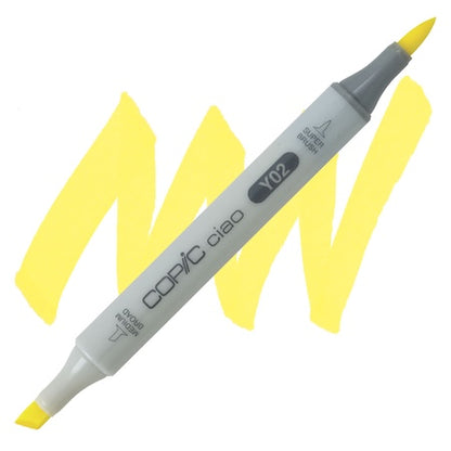 A double-ended Copic Ciao marker with a super brush tip on one end and a medium broad tip on the other, in a canary yellow color.
