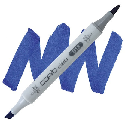 A Copic Ciao marker in Lapis Lazuli color with a double-ended design, showing a broad chisel tip and a fine point. The marker is labeled with the brand and product name, and is accompanied by swatches of the marker's color.
