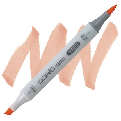 A double-ended Copic Ciao marker with a super brush tip on one end and a medium broad tip on the other, with a light orange ink color.