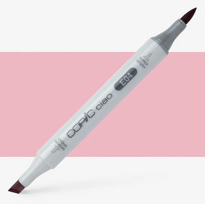 A double-ended Copic Ciao marker with a super brush tip on one end and a medium broad tip on the other, with a lipstick color applied to the tip.