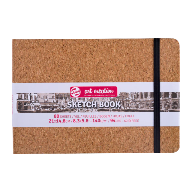 Cork sketchbook with a black strap closure on a white background