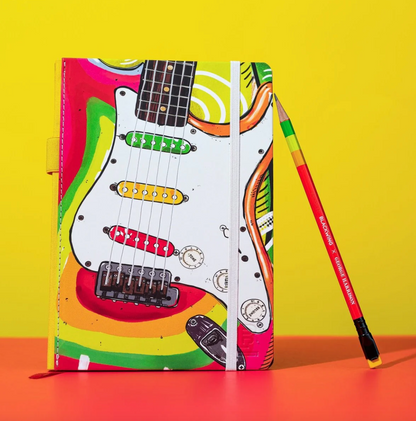 Colorful notebook with guitar design and a pencil on a yellow and orange background