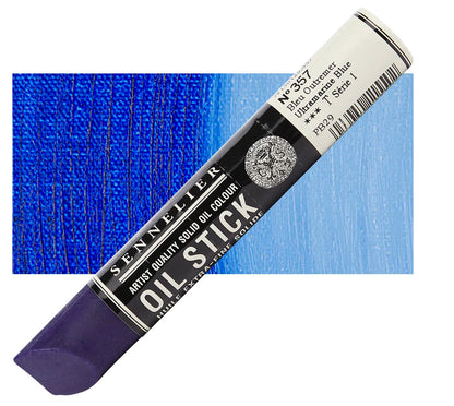 Blue oil stick with Sennelier branding against a blue textured background