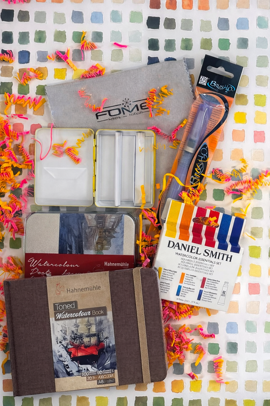 Art supplies including a notebook, watercolor set, and other items on a colorful checkered background.