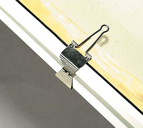 Close-up of a metal clip attached to a window frame with a neutral background
