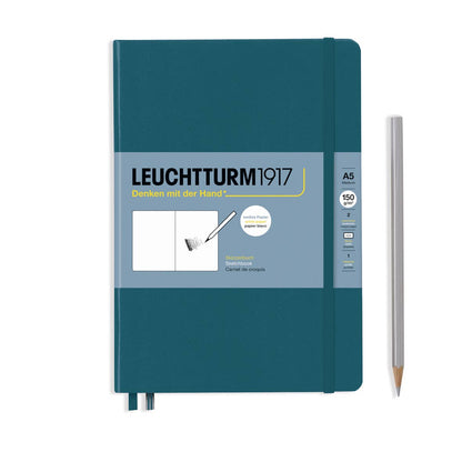 Teal notebook with Leuchtturm1917 branding and a pencil on a white background