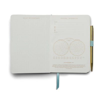 White notebook with gold text on a white background