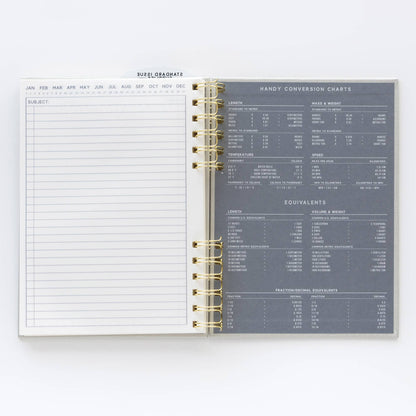 Open planner showing a calendar on one page and conversion charts on the other, on a white background.