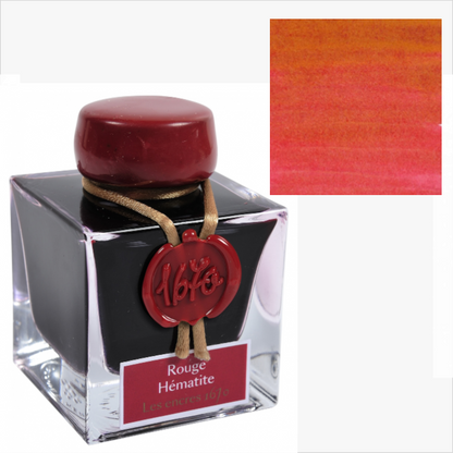 Ink bottle with red cap and label, featuring a color swatch of red ink.