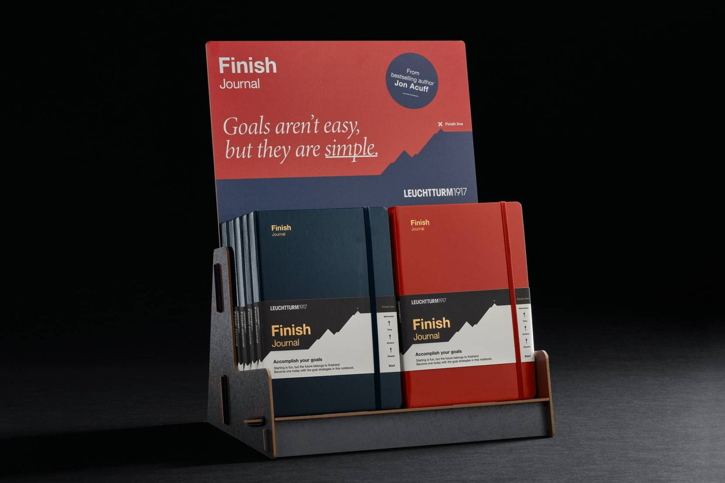 Display of 'Finish' journals in red, black, and white on a dark background