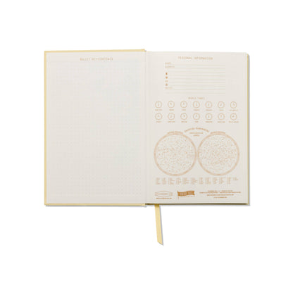Open book with gold text and design on a white background