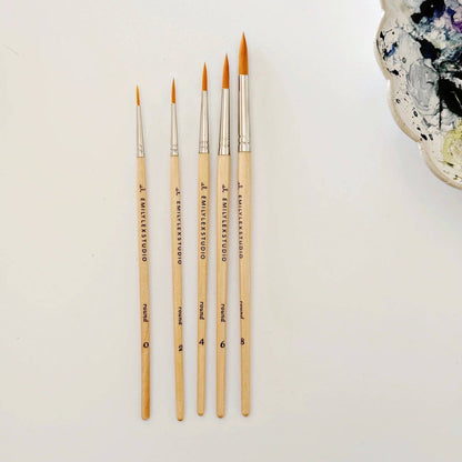 Set of paintbrushes with varying sizes on a light background