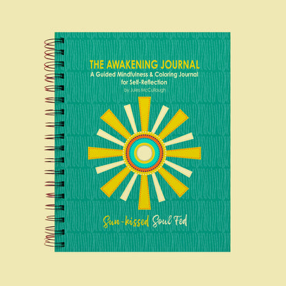 Journal titled 'The Awakening Journal' with a sun design on a beige background