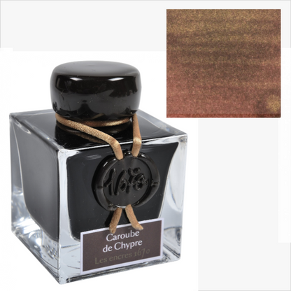 Ink bottle labeled 'Caroube de Chypre' with a color swatch inset on a white background