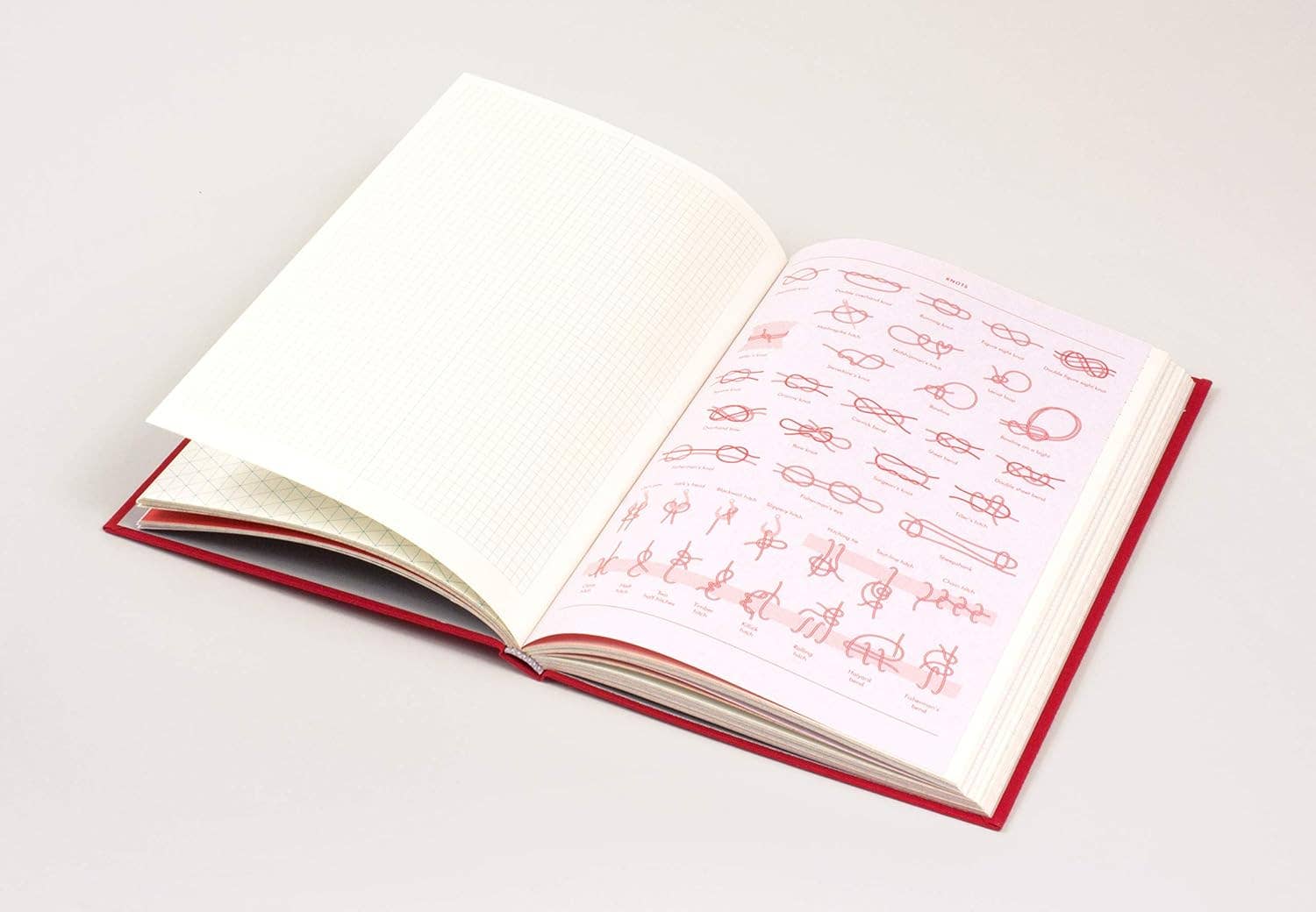 Open book with red text on white pages against a light gray background