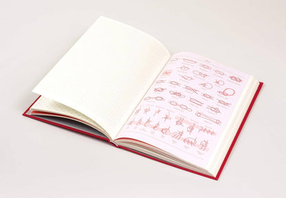 Open book with red text on white pages against a light gray background