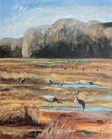 Painting of cranes in a landscape with mountains and water.